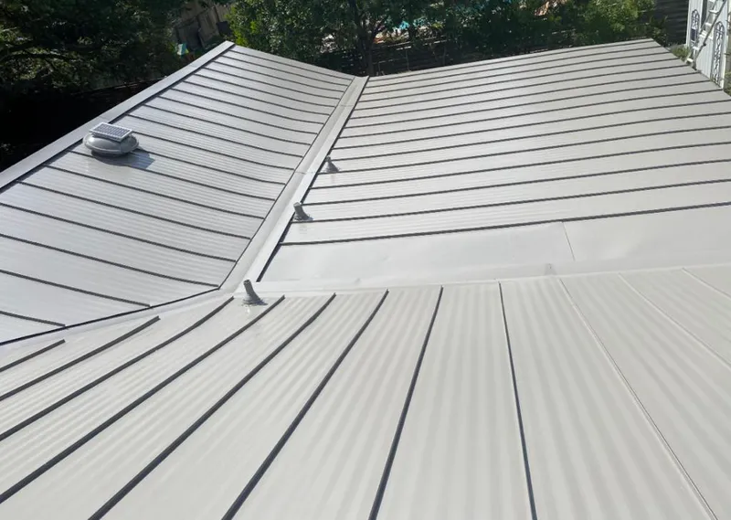 Solar attic fan installed on a metal roof for Roof Ventilation in Olney